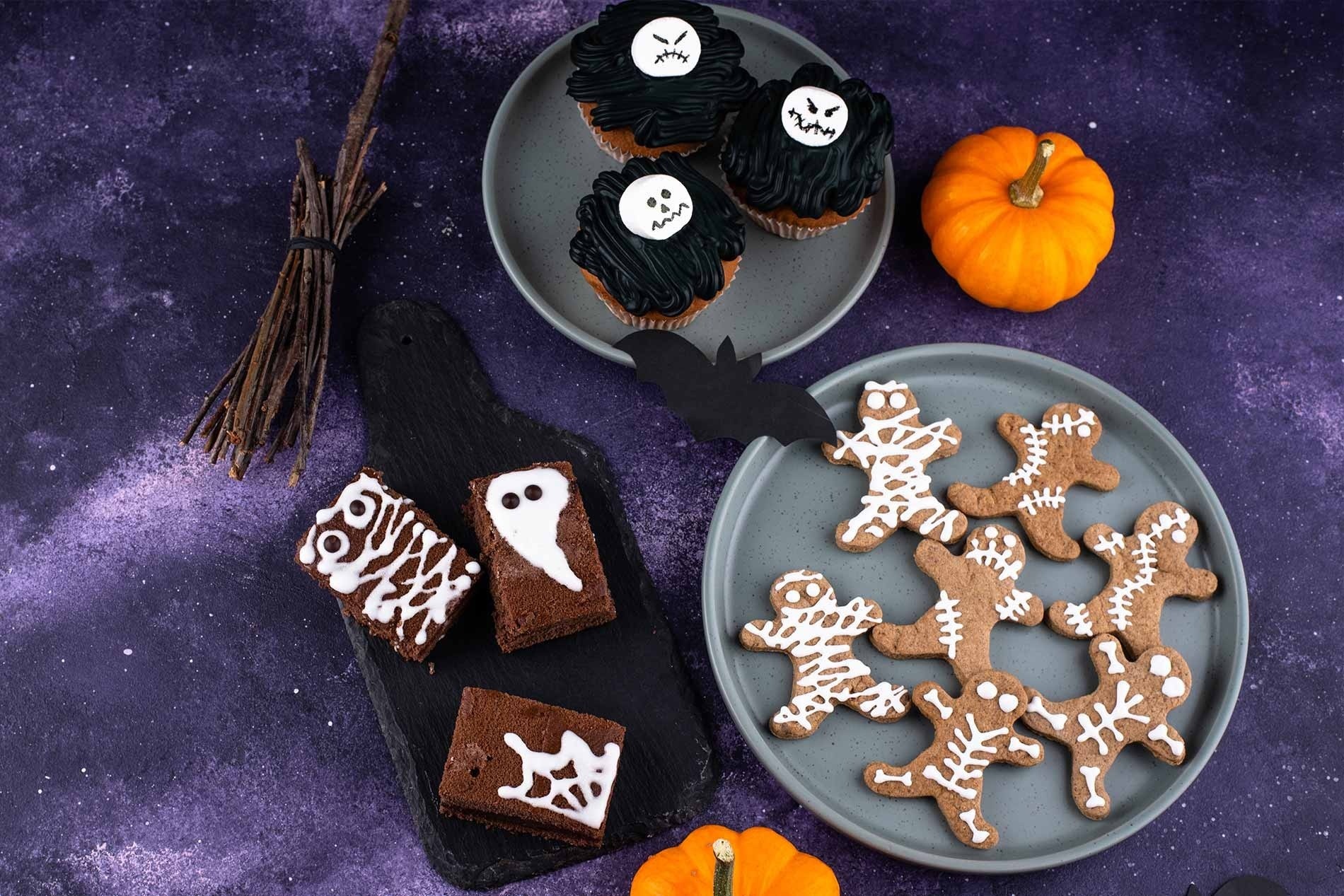 a bunch of halloween cookies on a blue background