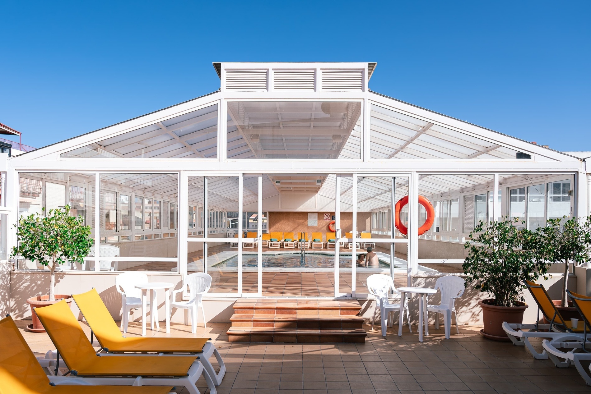 a swimming pool inside of a building with a life preserver