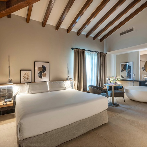 a hotel room with a king size bed and a bathtub