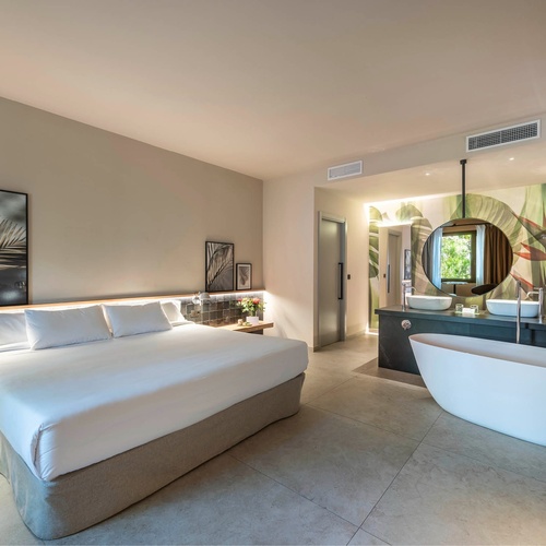 a hotel room with a large bed and a bathtub