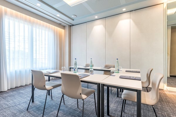 a conference room with tables and chairs set up for a port hotel meeting