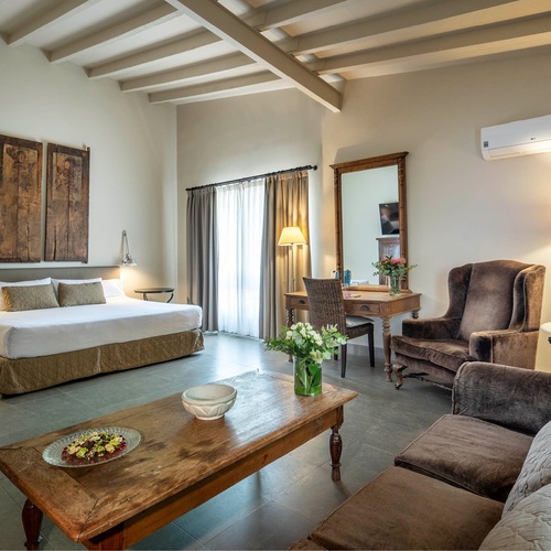 a hotel room with a large bed and a couch