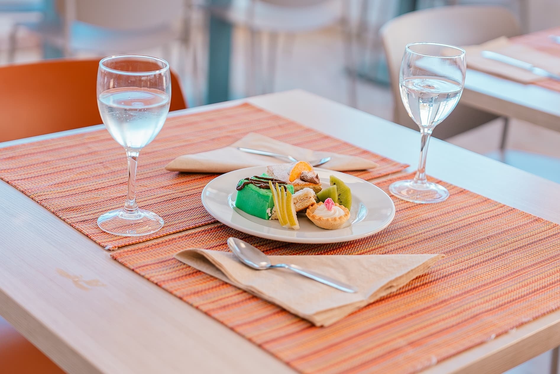 a table with a plate of food and a glass of water