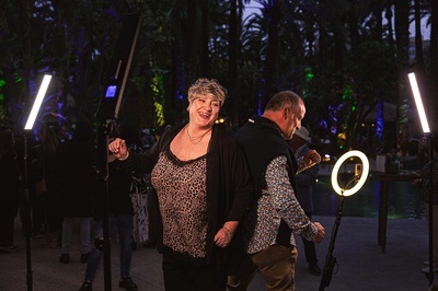a man and woman are posing for a picture with a ring light - 