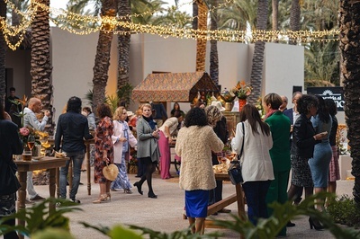 a group of people are gathered in front of a sign that says ' acacia ' on it - 