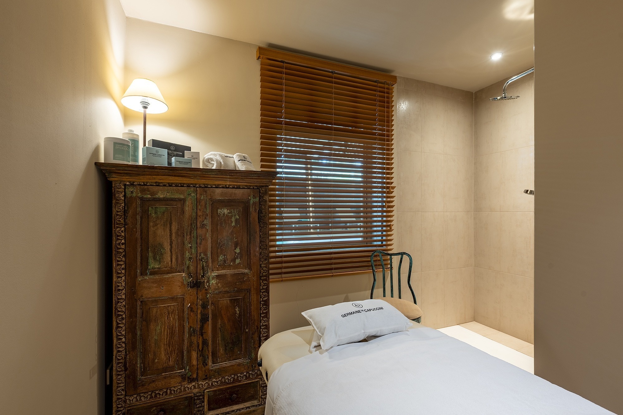 a hot tub is surrounded by lounge chairs under a wooden roof
