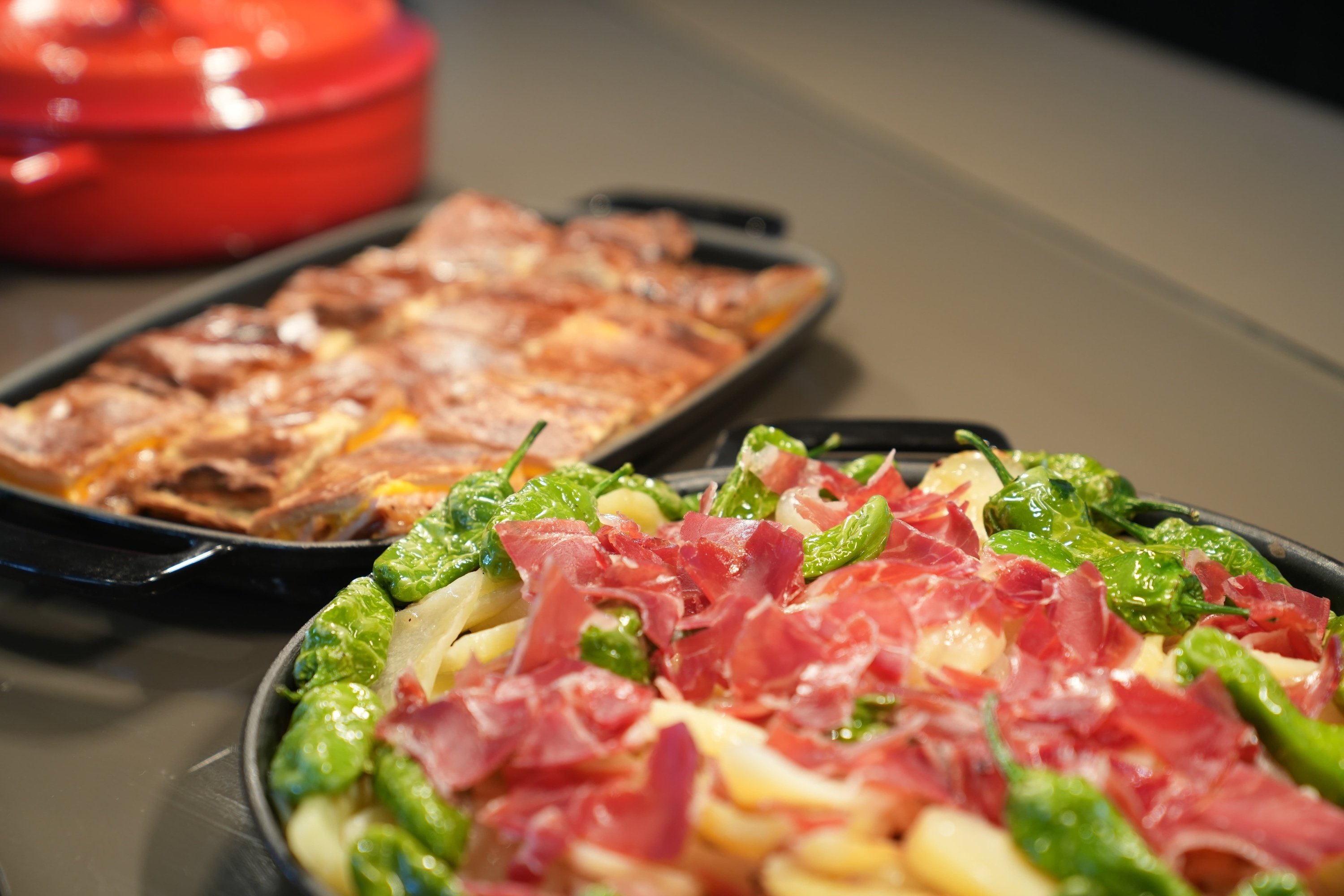 a plate of food with meat and green peppers on a table