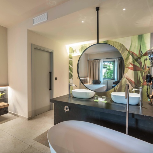 a bathroom with two sinks and a large mirror