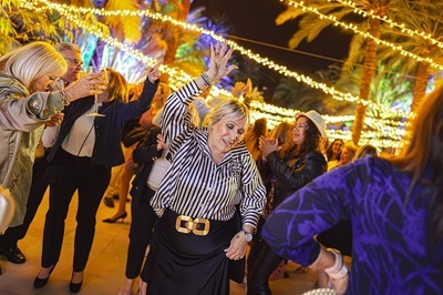 a woman in a black and white striped shirt has the number 60 on her belt - 