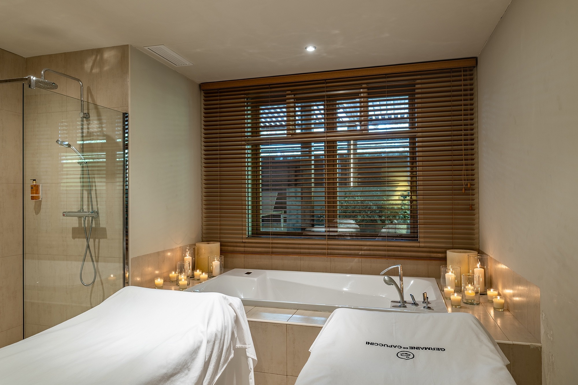 a hot tub is surrounded by lounge chairs under a wooden roof