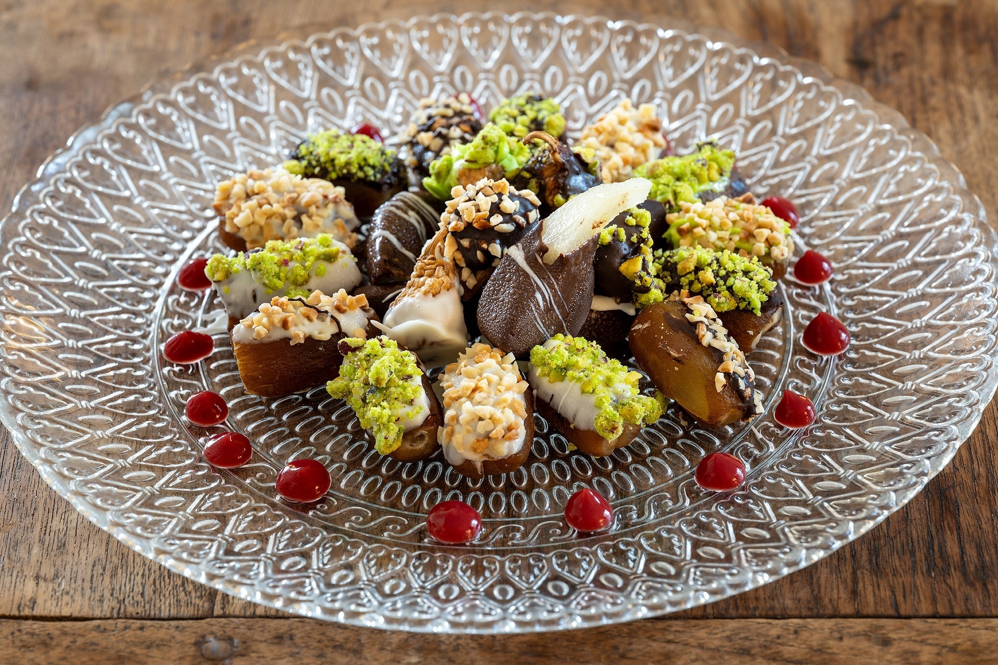 a glass plate with a variety of desserts on it