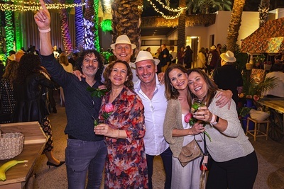 a group of people posing for a picture with one woman holding a rose - 