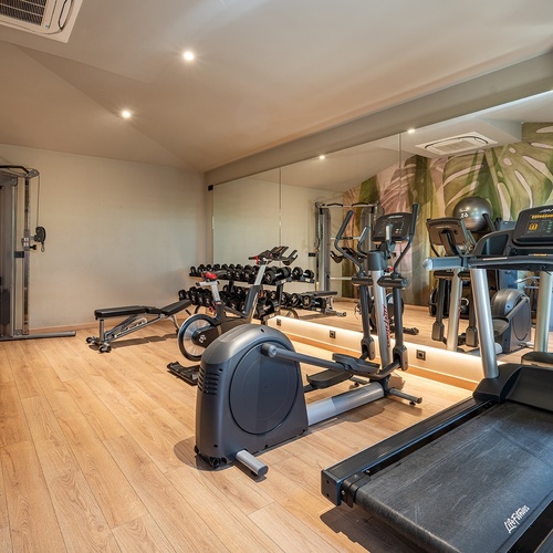 a gym with a treadmill that says life fitness on it