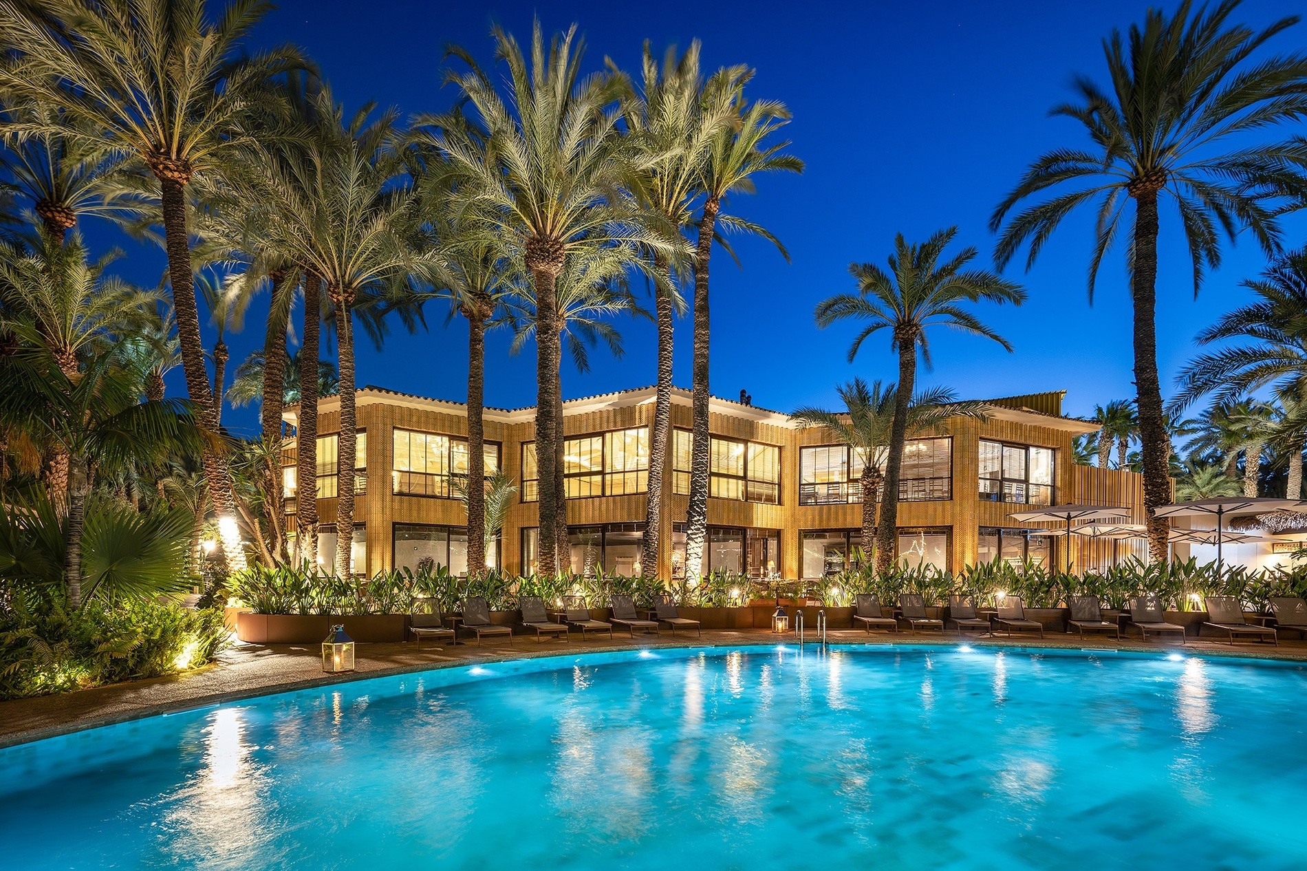 a large building with a swimming pool in front of it