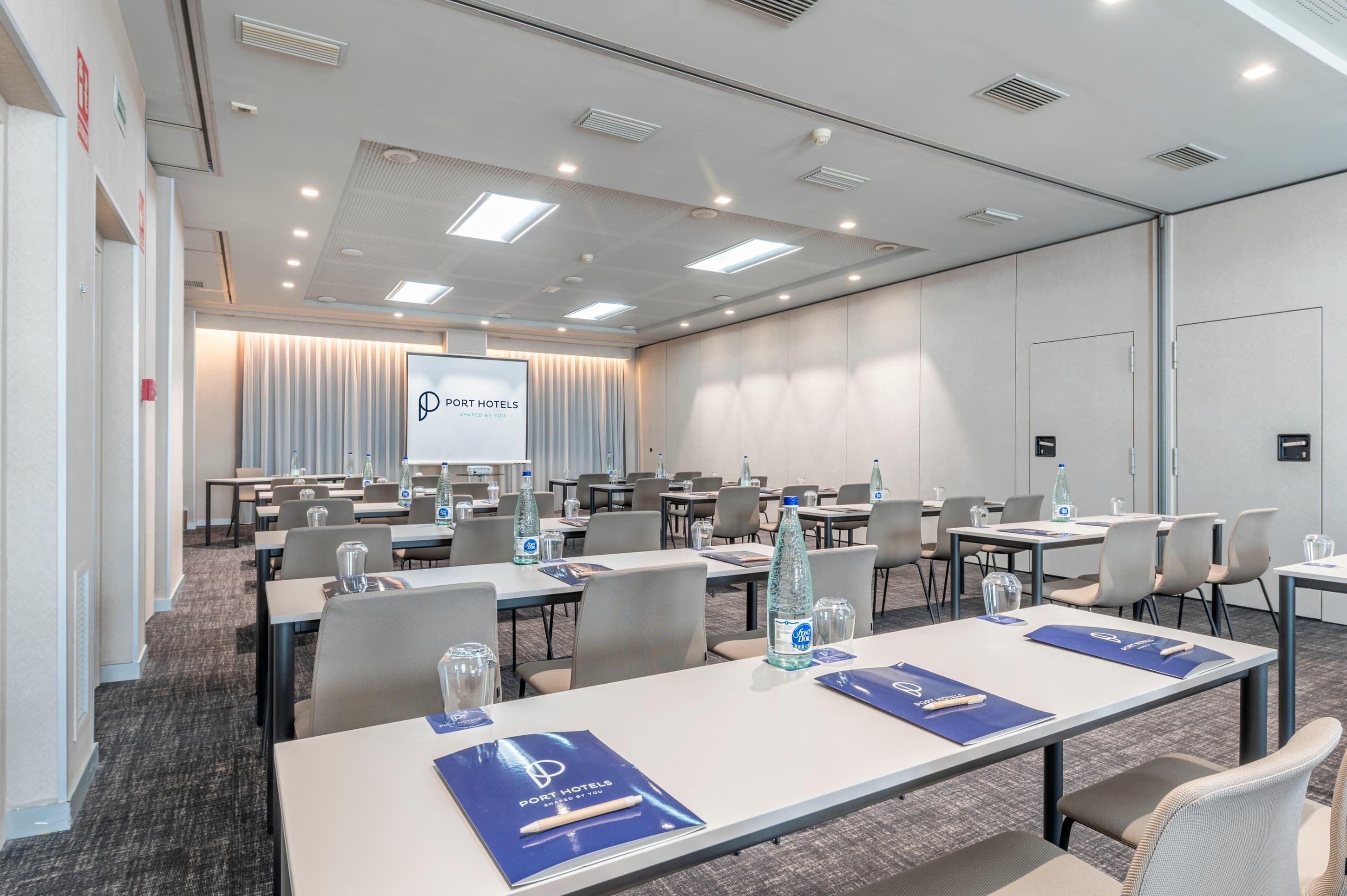 a conference room with tables and chairs set up for port hotels