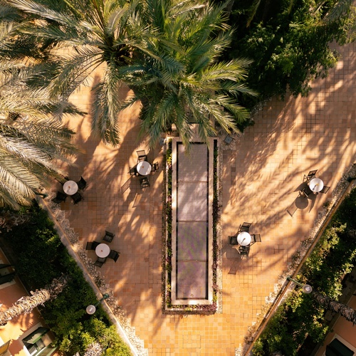 an aerial view of a patio with tables and chairs