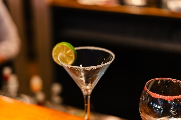 a man standing in front of a bar in a restaurant