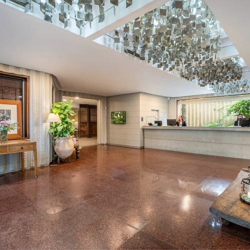 a hotel lobby with a reception desk and a table