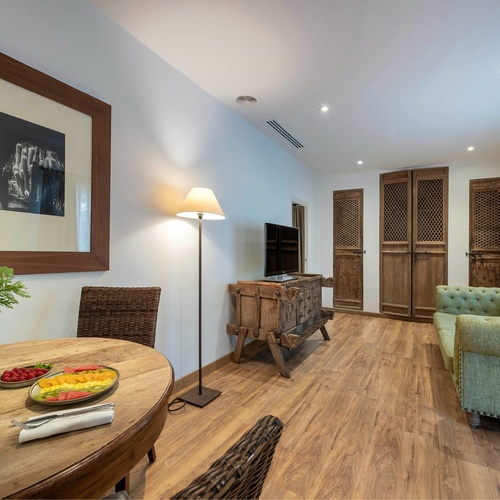 a living room with a couch a table and a picture on the wall