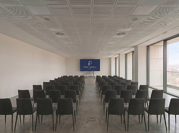 Sala de eventos corporativos en Port Hotels con asientos y pantalla gigante.