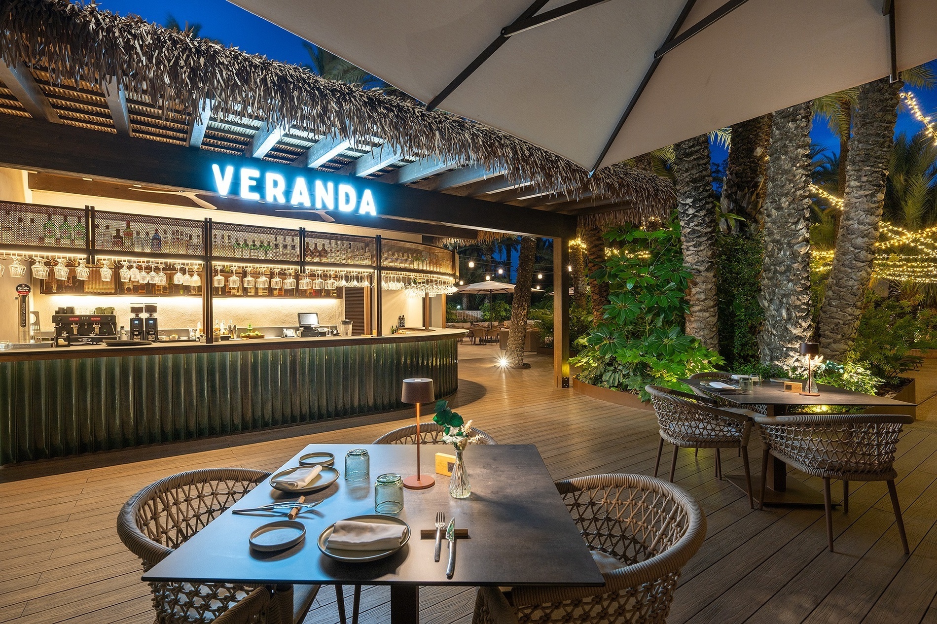a restaurant with tables and chairs under a sign that says veranda