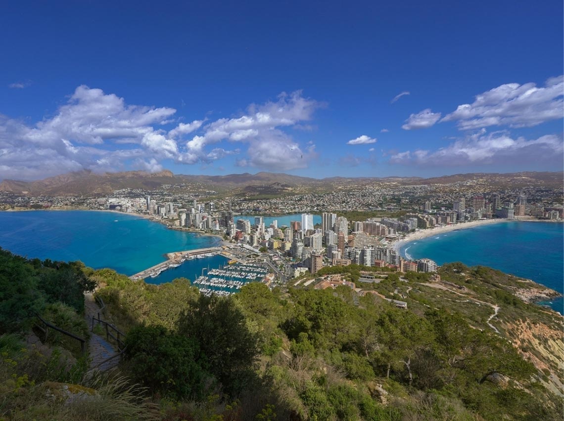 Vista aérea de hotéis em Benidorm com porto, ideal para estadias corporativas.