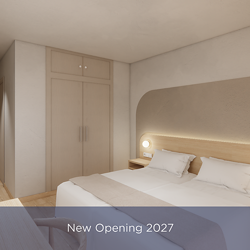 Modern hotel room with two beds and spacious closets, featuring a soft headboard and ambient lighting. Port Hotels: Corporativa