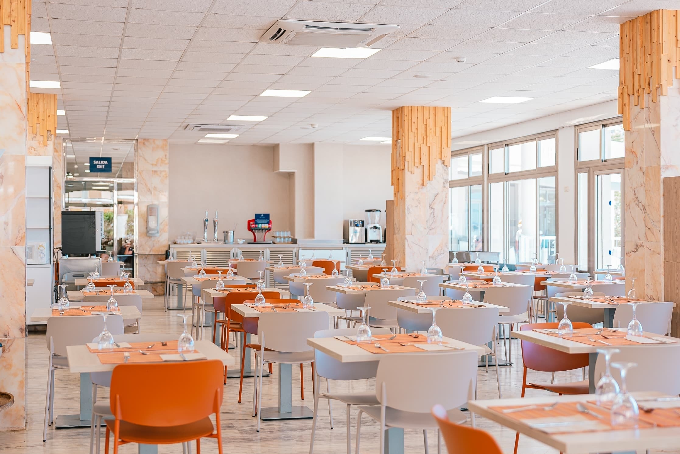 a restaurant with tables and chairs and a sign that says ' buffet ' on it