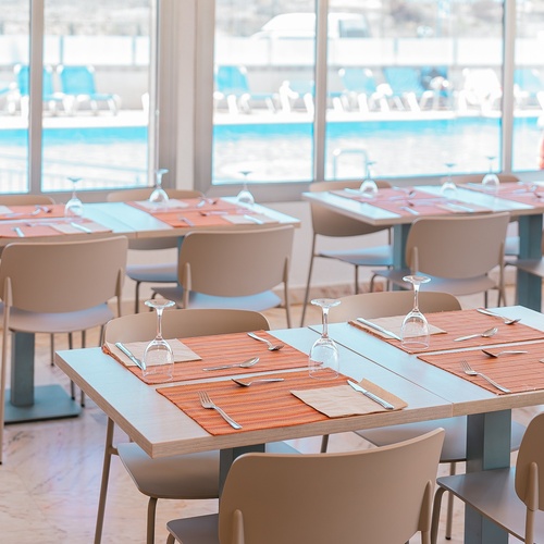 a restaurant with tables and chairs set for a meal