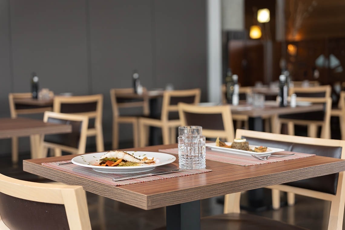 a restaurant table with a plate of food on it