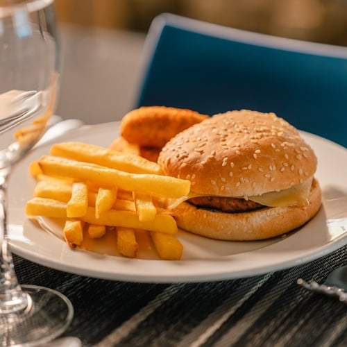 a white plate with a hamburger and french fries on it