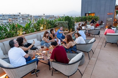 un grupo de personas se sienta alrededor de una mesa en una terraza - 