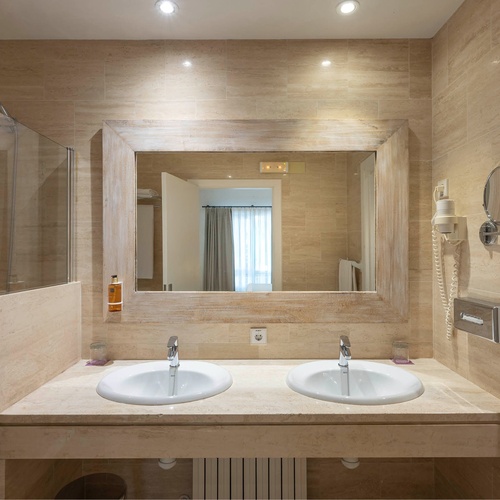 a bathroom with two sinks and a large mirror