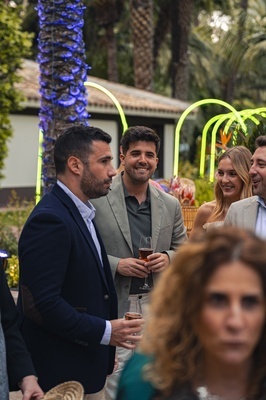 a man in a suit is holding a glass of wine - 