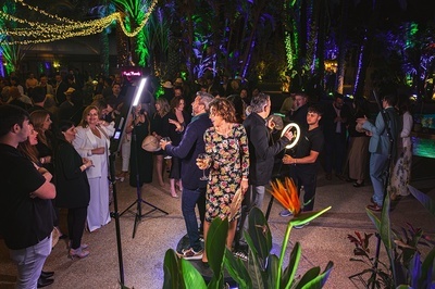 a crowd of people are gathered around a photo booth that says " selfie " on it - 