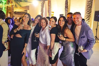 a group of people posing for a picture while holding wine glasses - 