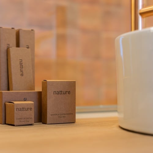 a box of nature soap sits next to a white sink