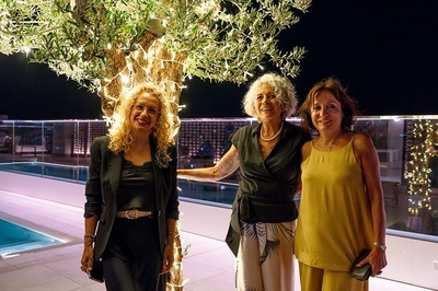 three women posing for a picture in front of a tree - 