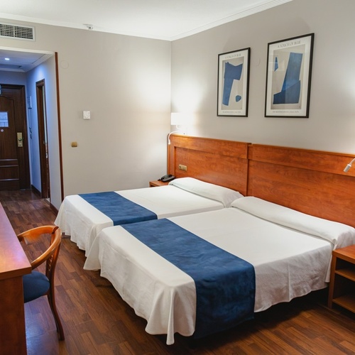 Port Hotels: Corporativa room with two beds, desk, and modern decor.
