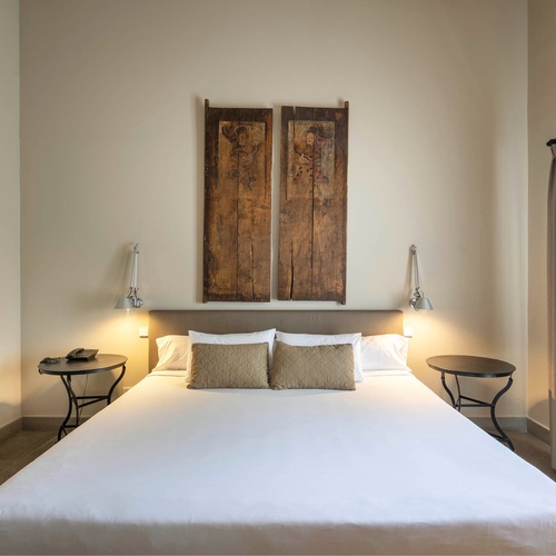 a hotel room with a bed and two tables