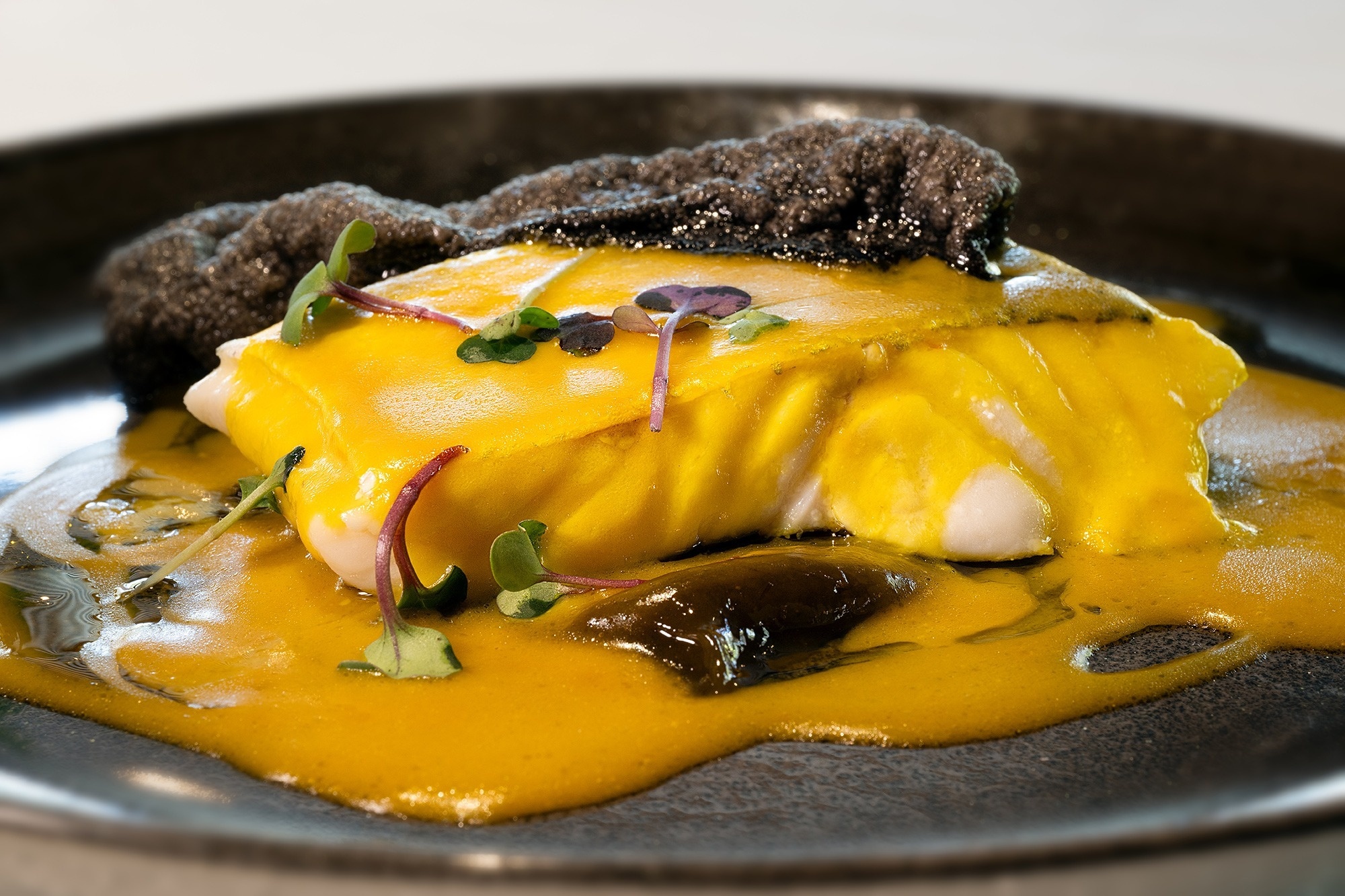 a close up of a plate of food with a yellow sauce