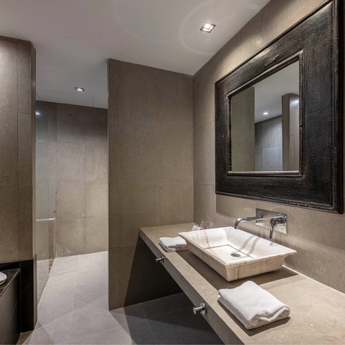 a bathroom with two sinks and a large mirror