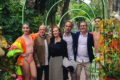 a group of people posing for a picture with a woman in a pink leotard - 