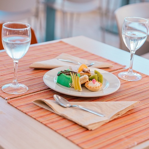 a table with a plate of food and two glasses of water