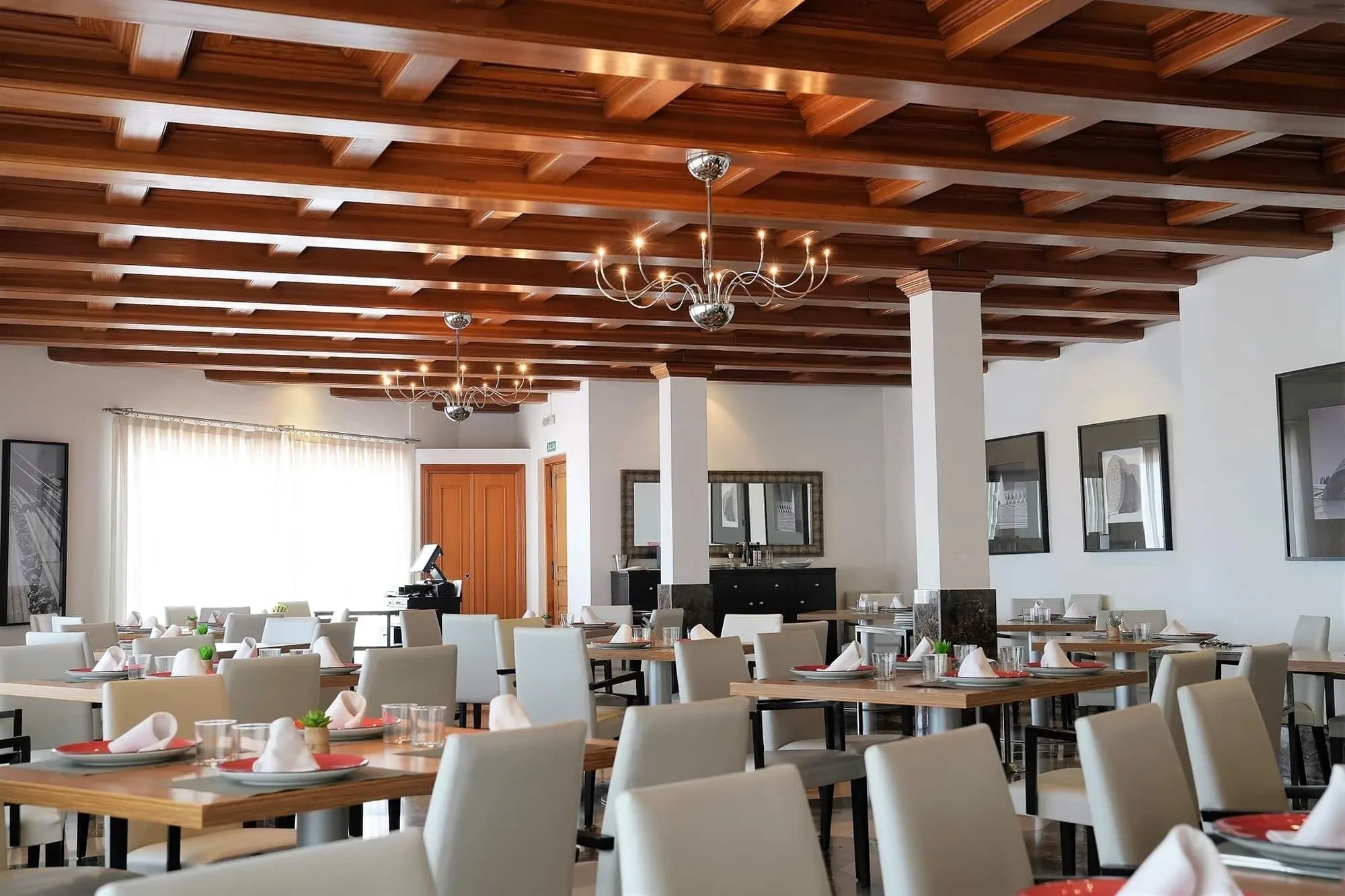 a dining room with tables and chairs and a chandelier