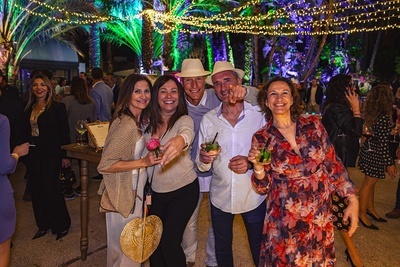 a group of people posing for a picture while holding drinks - 