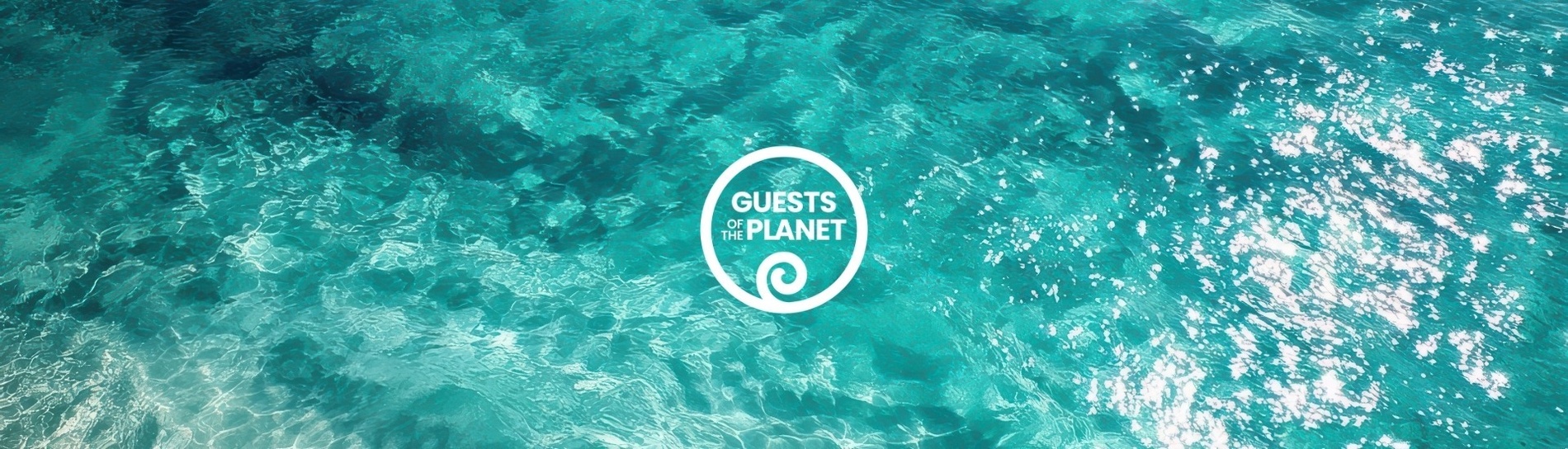 an aerial view of a body of water with a guests of the planet logo