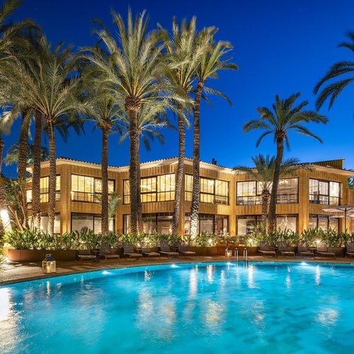 a large building with a swimming pool in front of it