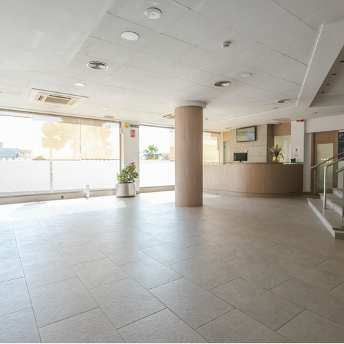 an empty lobby with stairs leading up to the second floor