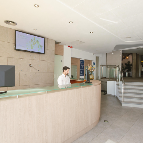 a man stands at a desk in front of a dell monitor